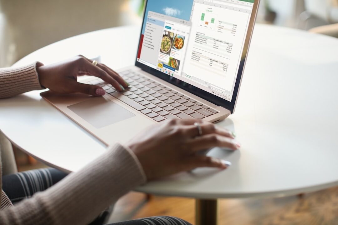 Hands typing on a laptop showing a growth analytics dashboard